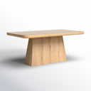Langston Dining Table in natural wood finish shown against a white background, featuring a thick rectangular tabletop with softly rounded corners and a tapered pedestal base.