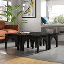 Remi charcoal black wood nesting coffee table set with arched cutout details in a modern living room