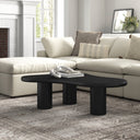 Reese black wood organic kidney shaped coffee table with chunky cylinder pillar legs in a living room