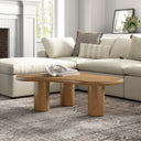 Reese natural light oak organic kidney shaped coffee table with chunky cylinder pillar legs in a living room
