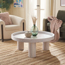 Dennis round white wash wood tray top coffee table with chunky cylinder legs styled in a living room