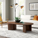 Louie oval walnut wood coffee table with curved panel slab legs styled in a modern living room