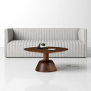 Boston round walnut wood coffee table with sculpted pedestal dome base styled in a living room