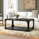 Kingsley rectangular black wood coffee table with open shelf and curved cutout frame in a living room