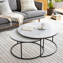 Zayn Genuine Marble Coffee Table nesting set styled in a living room with a gray sofa, books, coffee cup, and textured rug.