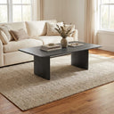 Scott rectangular black wood coffee table with slab legs styled in a living room