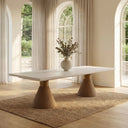 Angled product view of the Skyler rectangular dining table in a light natural finish with textured pedestal bases and a white tabletop.