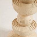 Close up view of Mylo side table base showcasing fluted ridges and concentric wood grain
