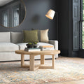 Blaise round solid wood coffee table styling in a modern living room setting