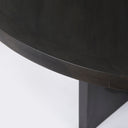 Angled view of the black Loyal Round 6 Seater Dining Table showcasing the circular cutout pedestal and smooth round tabletop.