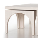 Close up side view of smaller modular arched nested tables tucked under main Remi coffee table frame