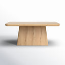 Front view of the natural wood Langston Dining Table highlighting its broad tabletop and substantial tapered pedestal base.