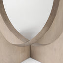 Close-up of the Loyal dining table's circular pedestal showing the intersecting curved wood panels and smooth natural finish.