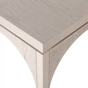 Close up corner profile view of a single Remi nesting coffee table showing sharp mitered joints and arched leg silhouette