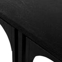 Close up corner view of a charcoal black Remi nesting coffee table showing wood grain and nested leg alignment