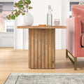Aron square solid wood end table with fluted pedestal base styled in a room