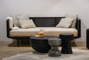 Salem grey textured hourglass accent table styled in a living room with black mesh back daybed sofa