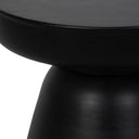 Macro view of black drum table neck showing smooth matte finish and pedestal joints