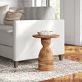 Salvador natural mango wood hourglass sculptural end table styled next to a white couch