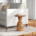 Salvador natural mango wood hourglass sculptural end table styled next to a white couch