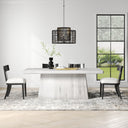 Langston Dining Table in whitewashed wood finish styled with dining chairs, pendant lighting, decorative greenery, and a neutral patterned rug.