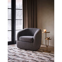 Modern End Table - Maximo Round Pedestal Side Table in a solid wood design beside an upholstered chair.
