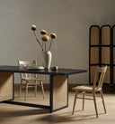 Detailed lower section of the Dennis Woven Dining Table showing the woven panel, framed leg and connecting support rail.