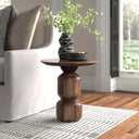 Tommy round dark brown solid wood end table with stacked ball pedestal base styled in a room
