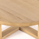 Close up angle view of Blaise coffee table showing thick rounded tabletop edge and base joinery