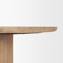 Close-up of the Mylo Round Dining Table showing the softly rounded tabletop edge and curved pedestal connection.