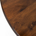 Hugh Round 6 Seater Dining Table styled in a classic dining room with six upholstered chairs, chandelier lighting, and traditional wood furnishings.