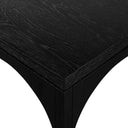 Close up corner profile view of a single charcoal black Remi nesting coffee table showing sharp mitered joints and arched leg silhouette