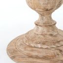 Detailed view of the Hugh Dining Table’s tiered pedestal base, highlighting its layered circular construction and textured natural wood finish.