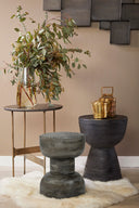 Three different grey textured solid wood coffee and accent tables shown together in an alternative lifestyle setting