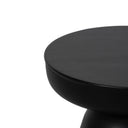 Macro view of black drum table top edge showing smooth matte finish texture