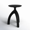 Cillian round black solid wood end table three-quarter studio view showcasing arched tripod legs