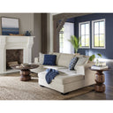 Rey round walnut coffee table and matching end table styled with a sectional sofa
