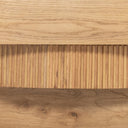 Macro view of textured fluted detail and solid wood grain on Harry coffee table base layers