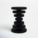Clyde round black solid wood end table side studio view showcasing stacked geometric disc base