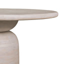 Close-up of the Tomas Round 6 Seater Dining Table showing its smooth rounded tabletop edge and sculptural light wood pedestal base.