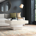 Ben square cream coffee table with textured fluted pedestal base in a dark modern living room