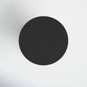 Top down view of black concrete drum table showing flat circular matte surface