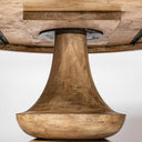 Detailed underside view of the Musa Round Dining Table showing the wooden pedestal connection and tabletop support structure.