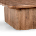 Close up detail of curved block pedestal base structure on Brendan solid wood coffee table