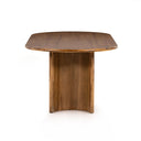 Kiaan Oval 6 Seater Dining Table in natural wood finish shown from a close side angle, highlighting the curved pedestal leg and tabletop profile.