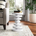 Clyde round white solid wood end table with stacked geometric disc pedestal base styled in a room