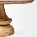 Close-up side view of the Musa Round Dining Table highlighting the curved tabletop edge and tapered central pedestal.