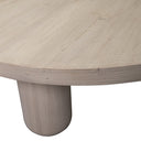 Close up angle view of Vicente coffee table showing thick tabletop edge and smooth cylindrical leg
