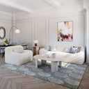 Jefferson oval light wood coffee table styled in a complete living room scene with a ribbed cream sofa and accent chair