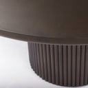 Close-up of the Mylo Dining Table tabletop edge, showing its smooth finish, rounded profile, and natural dark wood grain.